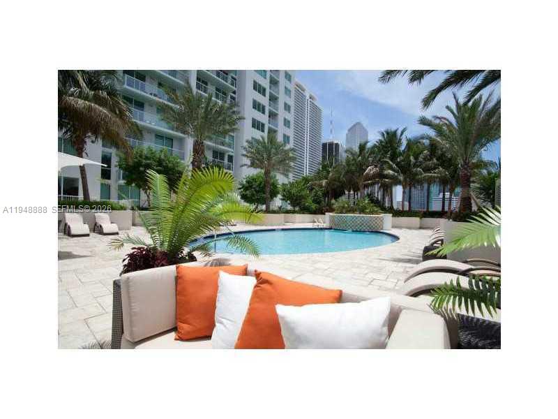 244 Biscayne Boulevard, Unit 702 Miami, FL 33132 - Photo 8 of 12 a view of swimming pool with outdoor seating and plants