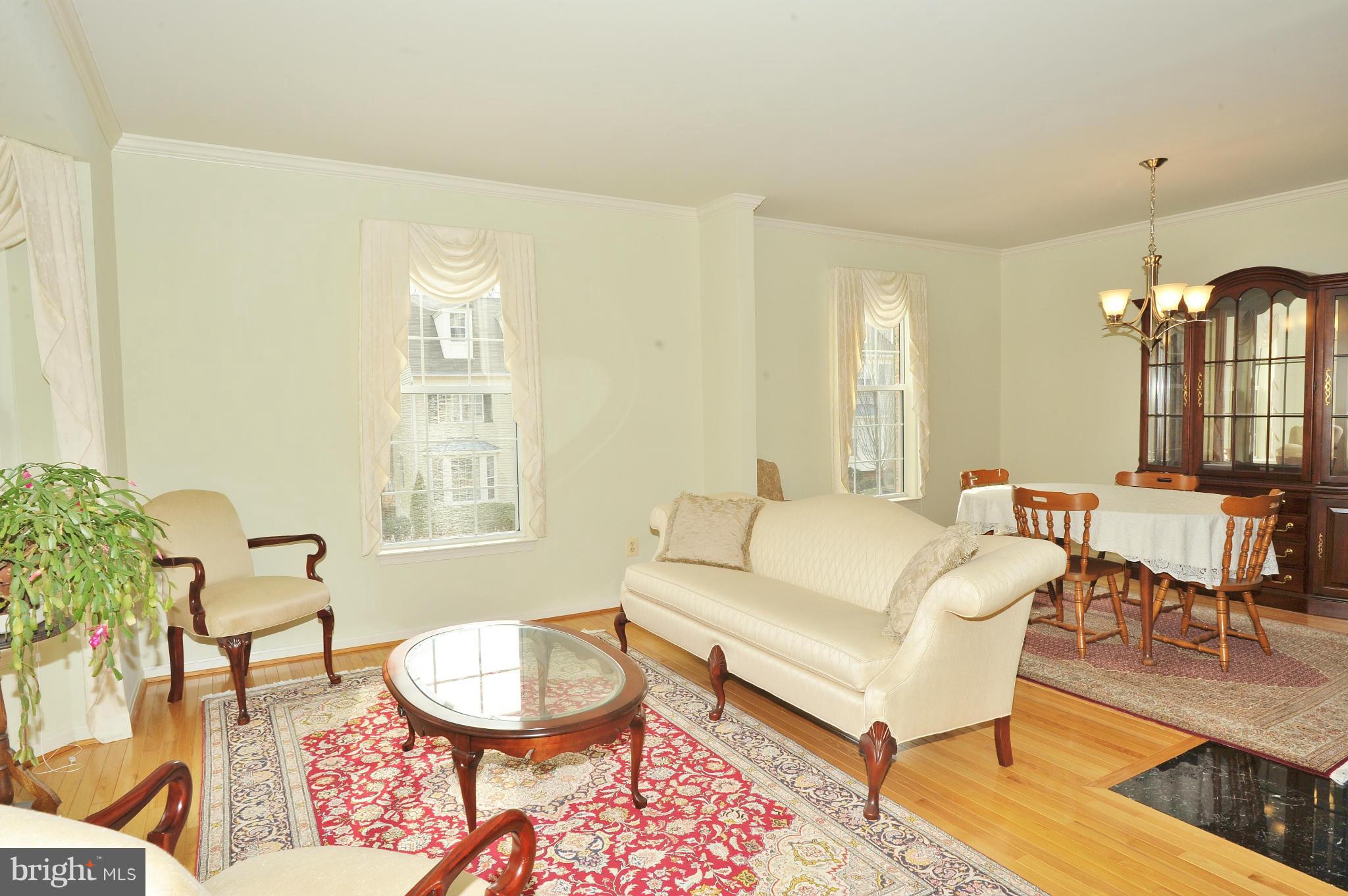 5700 Clapham Road Alexandria, VA 22315 - Photo 12 of 30 a living room with furniture a lamp and a dining table