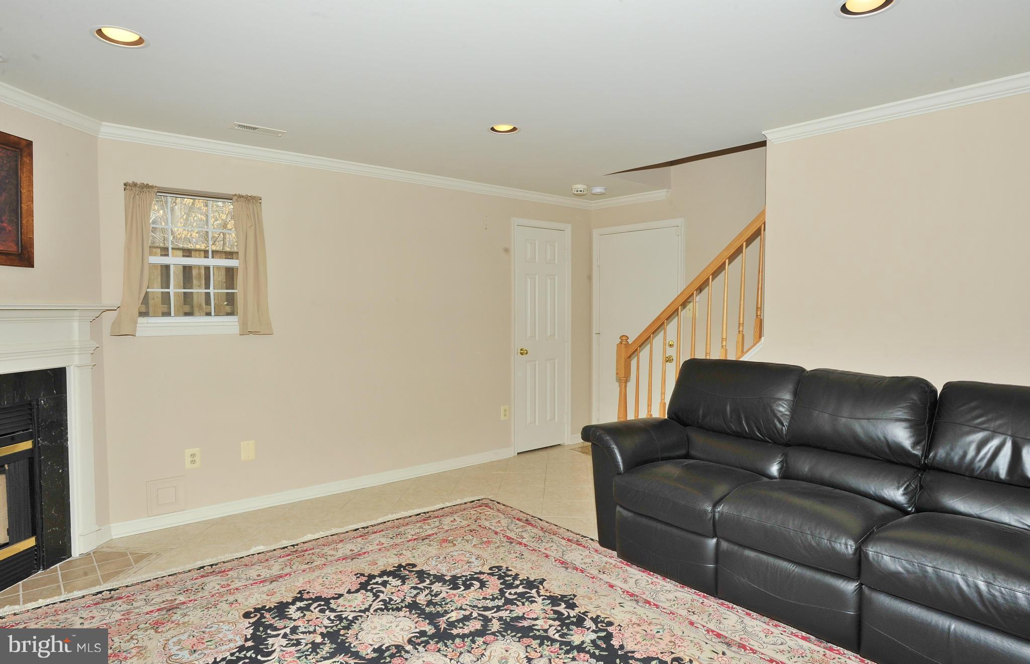 5700 Clapham Road Alexandria, VA 22315 - Photo 17 of 30 a living room with furniture and a rug