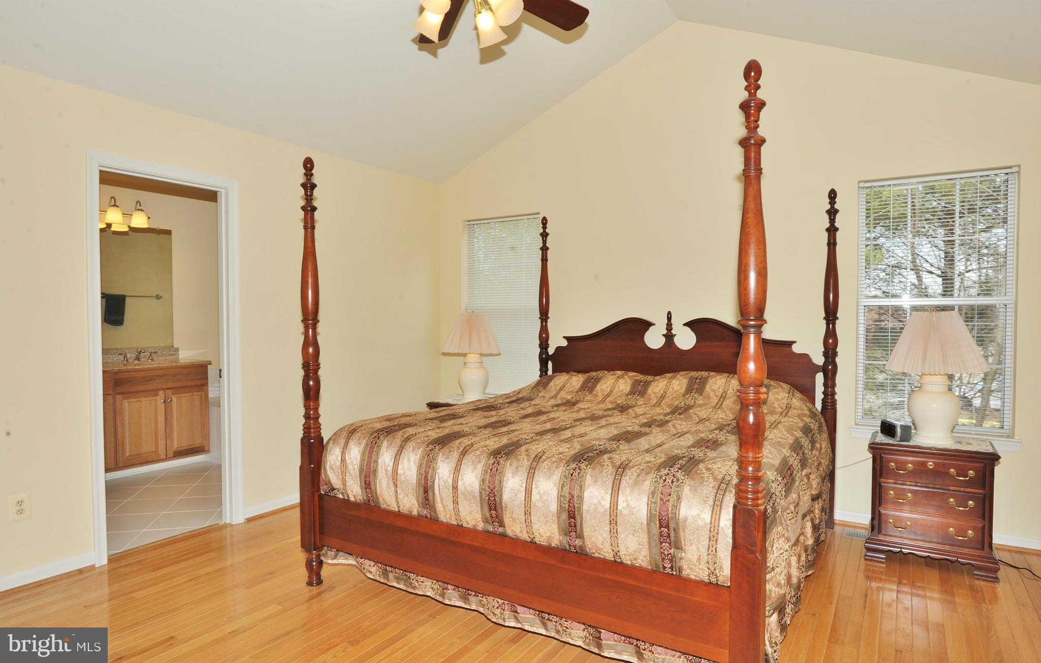5700 Clapham Road Alexandria, VA 22315 - Photo 20 of 30 a bedroom with a bed and wooden floor