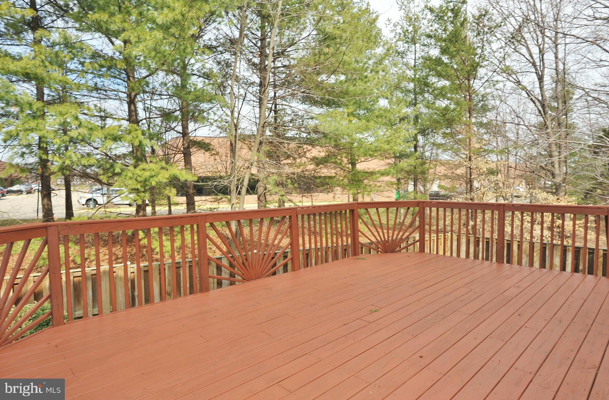 5700 Clapham Road Alexandria, VA 22315 - Photo 27 of 30 a balcony with wooden floor and trees