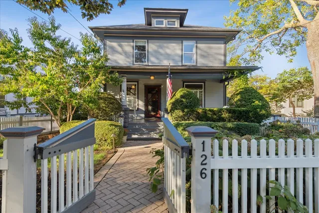 a view of a house with wooden fence