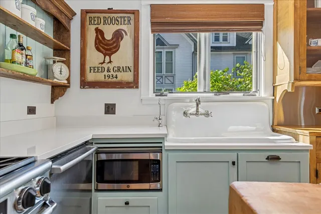 a kitchen with stainless steel appliances granite countertop a sink and a refrigerator