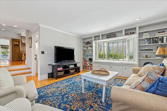 a living room with furniture a rug and a flat screen tv