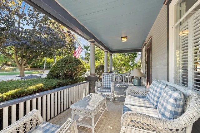 a view of a patio with a table chairs and a porch
