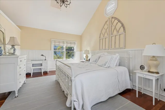 a spacious bedroom with a bed and a window