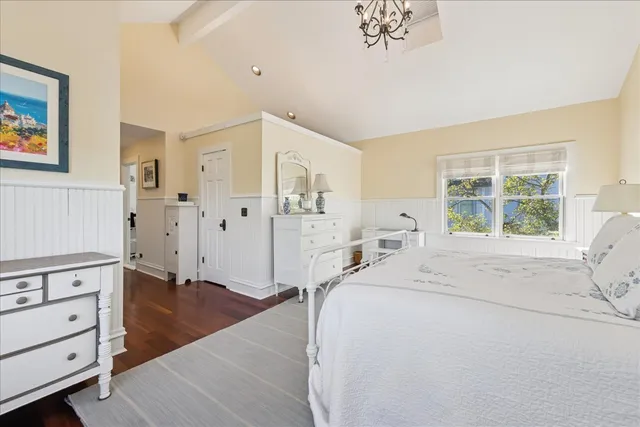 a view of a bedroom with wooden floor and cabinet