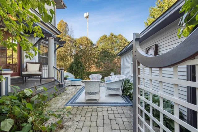 a view of a patio with couches table and chairs and potted plants