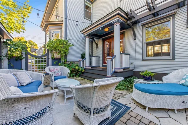 a view of a patio with table and chairs and potted plants