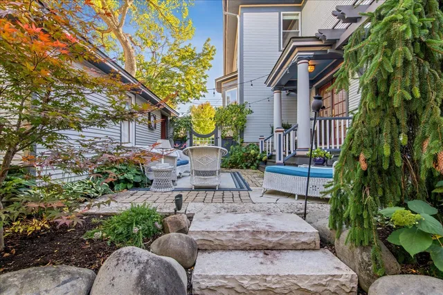 a front view of a house with a yard and fountain