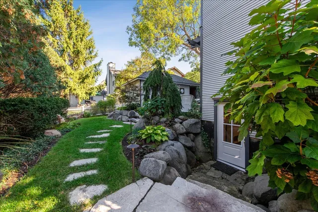 a living room with furniture a flat screen tv and kitchen view