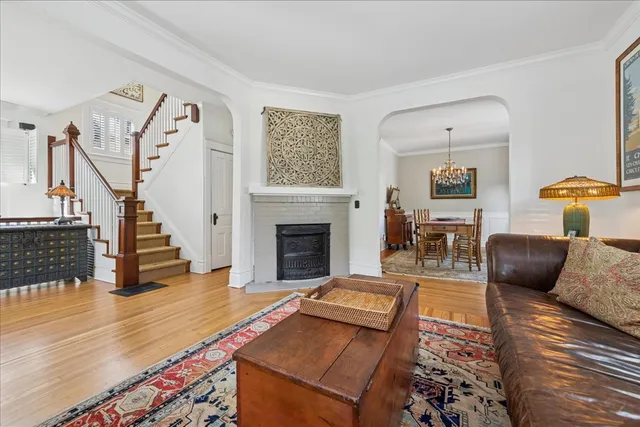 a living room with fireplace furniture and a rug