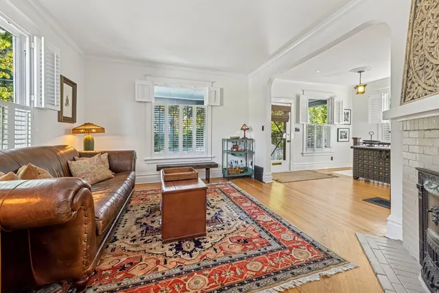 a dining room with furniture a chandelier and wooden floor