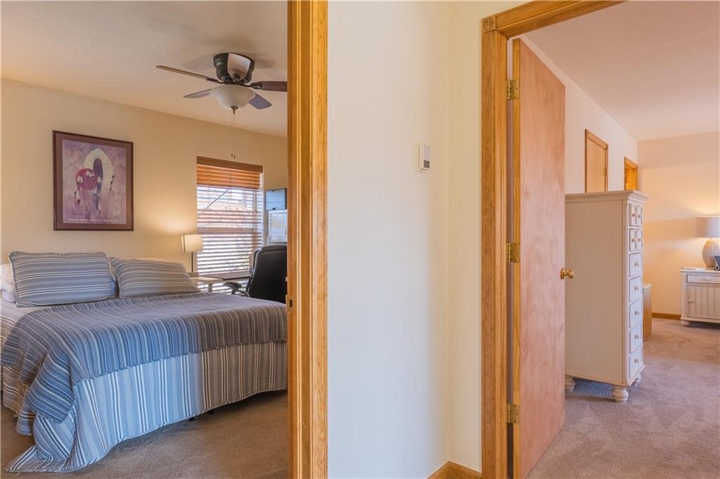 7 Lookout Ridge Drive, Unit 7 Dillon, CO 80435 - Photo 14 of 35 a bedroom with a bed and a painting on the wall