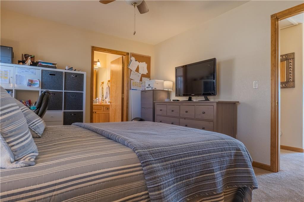 7 Lookout Ridge Drive, Unit 7 Dillon, CO 80435 - Photo 17 of 35 a bedroom with a bed and a flat tv screen on wall