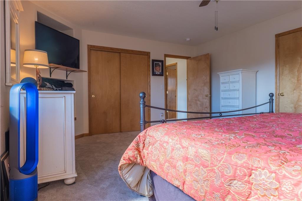 7 Lookout Ridge Drive, Unit 7 Dillon, CO 80435 - Photo 23 of 35 a bedroom with a bed and a flat tv screen on dresser