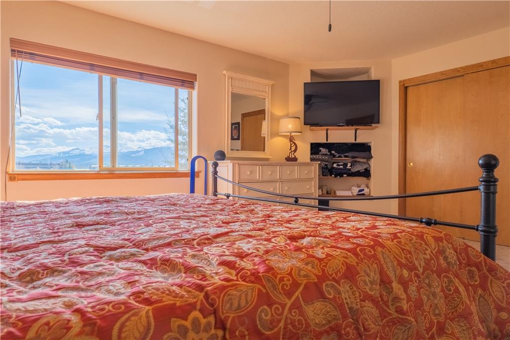 7 Lookout Ridge Drive, Unit 7 Dillon, CO 80435 - Photo 24 of 35 a bedroom with a bed and a flat screen tv