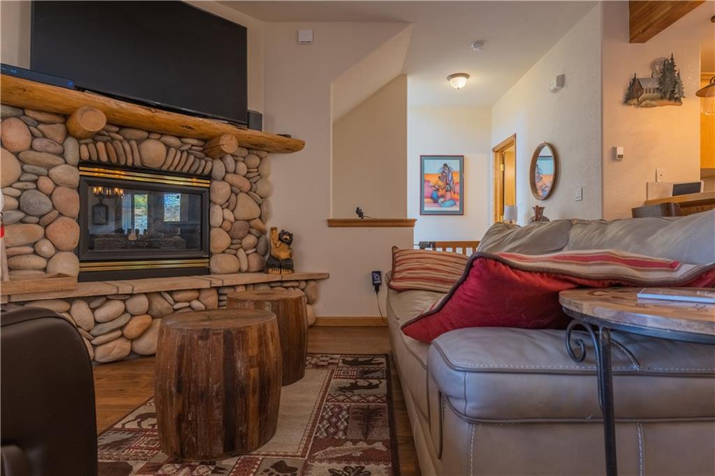 7 Lookout Ridge Drive, Unit 7 Dillon, CO 80435 - Photo 4 of 35 a living room with furniture a flat screen tv and kitchen view