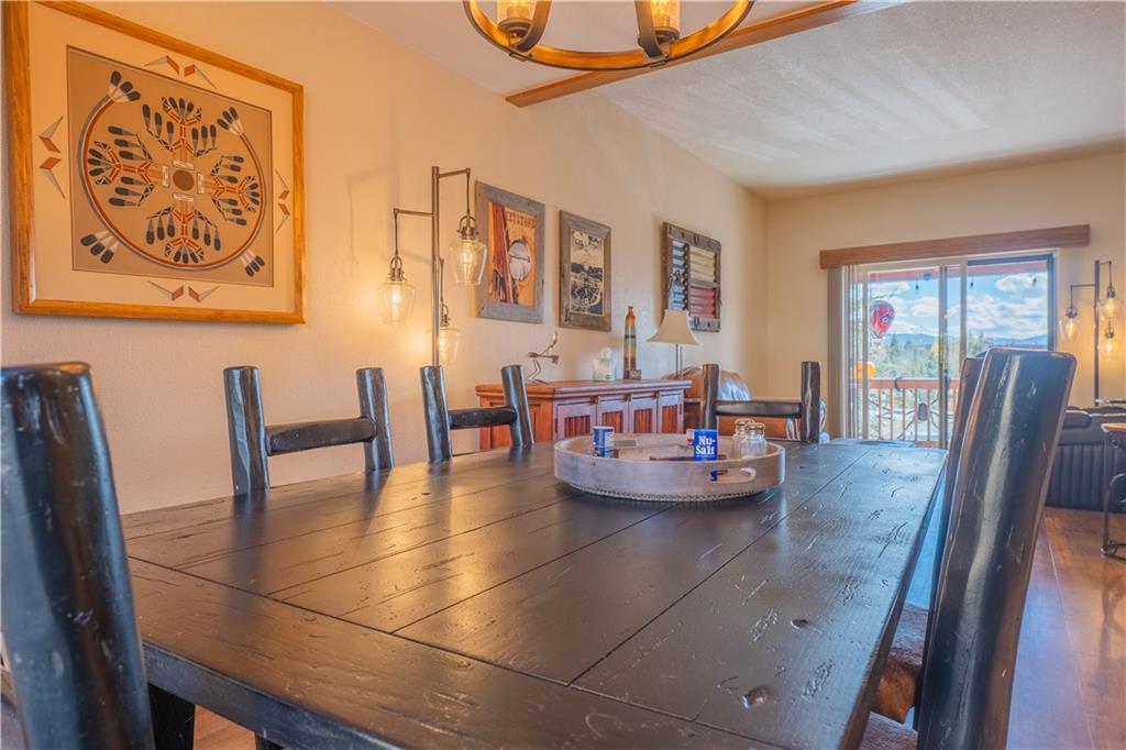 7 Lookout Ridge Drive, Unit 7 Dillon, CO 80435 - Photo 8 of 35 a dining room with furniture and wooden floor