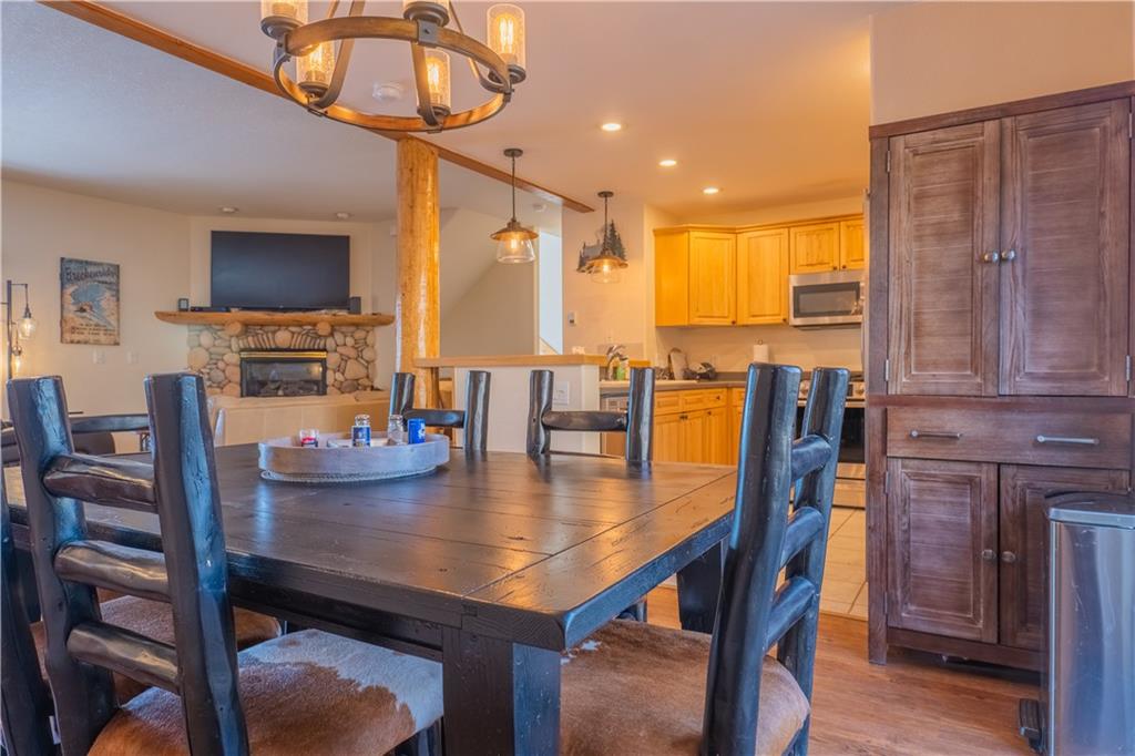 7 Lookout Ridge Drive, Unit 7 Dillon, CO 80435 - Photo 9 of 35 a view of a dining room with furniture a chandelier and wooden floor