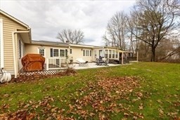 9 Register Avenue, Unit 2 Westport, MA 02790 - Photo 3 of 11 a front view of house with yard and trees around