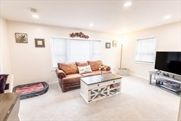 9 Register Avenue, Unit 2 Westport, MA 02790 - Photo 5 of 11 a bedroom with furniture and a flat screen tv