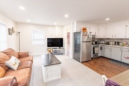 9 Register Avenue, Unit 2 Westport, MA 02790 - Photo 7 of 11 a kitchen with stainless steel appliances kitchen island granite countertop a refrigerator and a sink