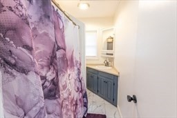 9 Register Avenue, Unit 2 Westport, MA 02790 - Photo 9 of 11 a bathroom with a sink and a mirror