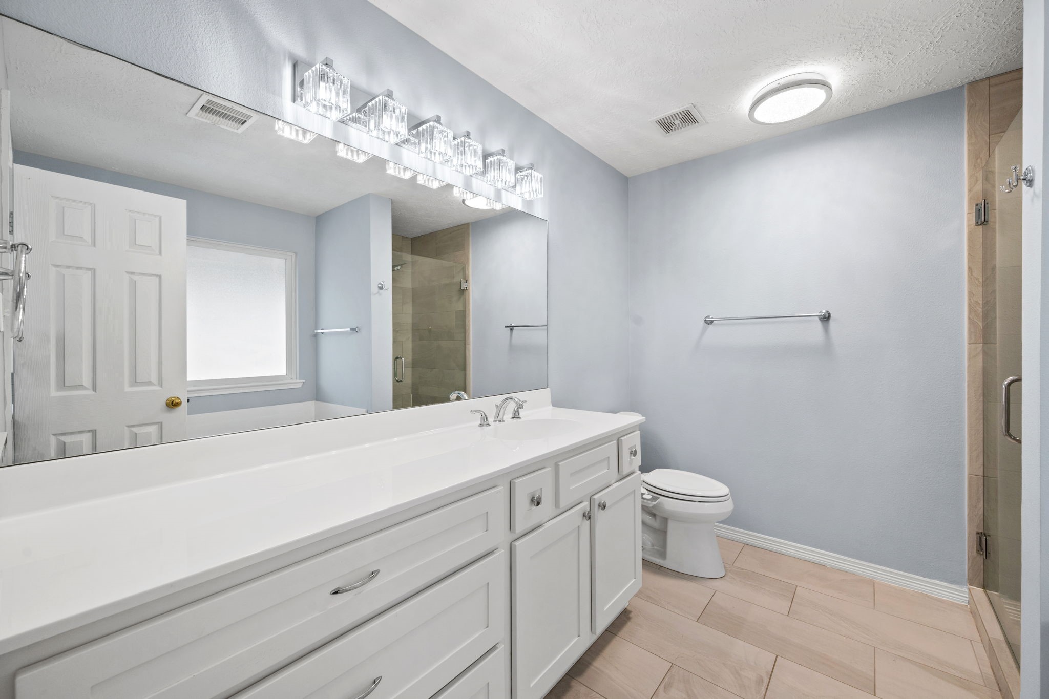 21893 Pinewilde Court Porter, TX 77365 - Photo 12 of 25 a spacious bathroom with a toilet sink and mirror