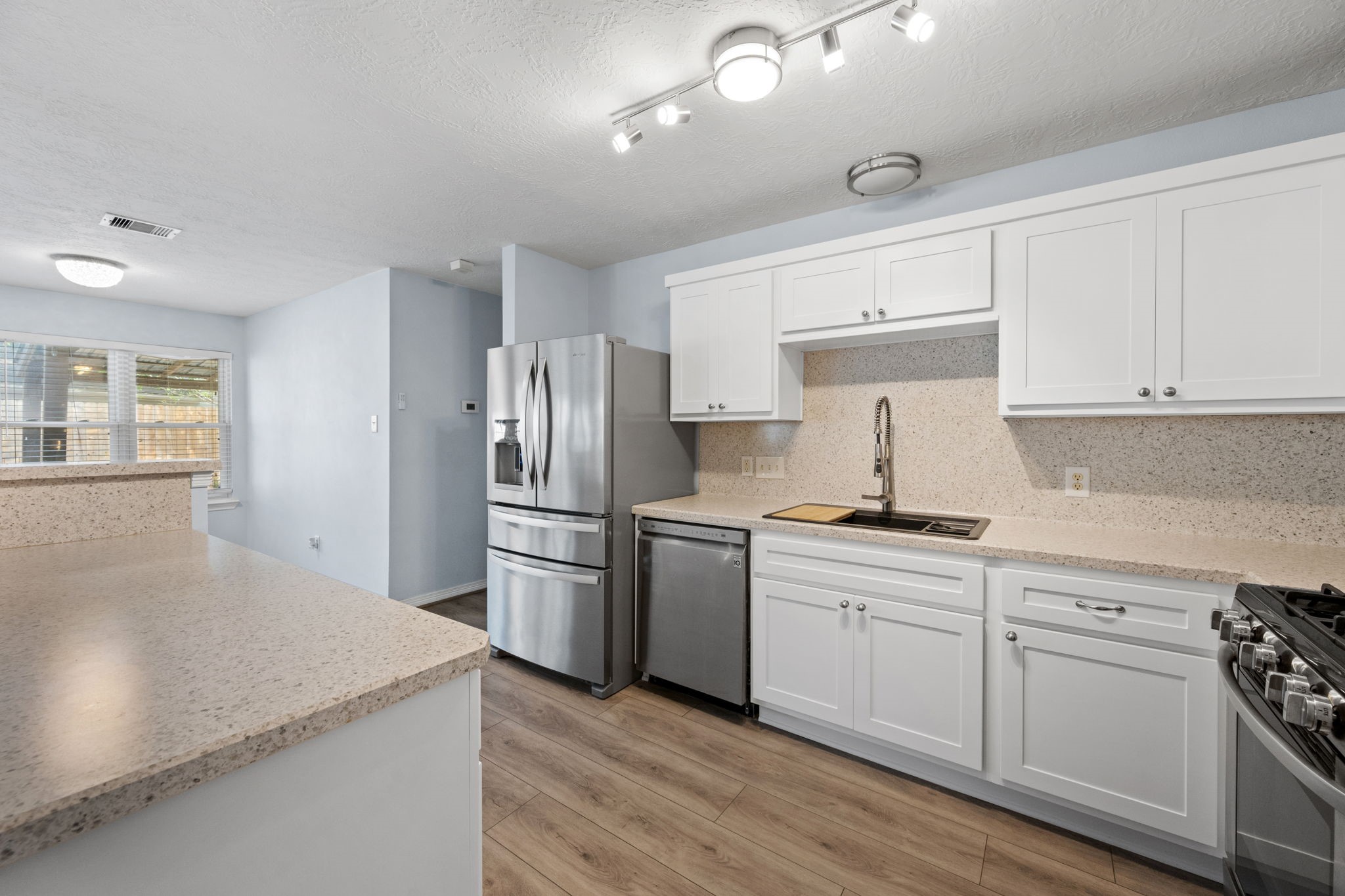 21893 Pinewilde Court Porter, TX 77365 - Photo 17 of 25 a kitchen with a sink a stove and refrigerator