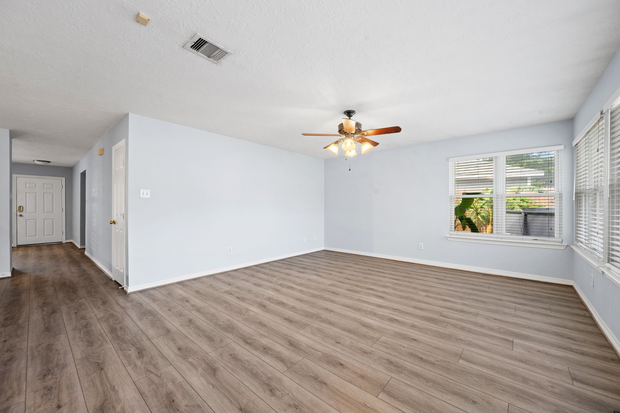 21893 Pinewilde Court Porter, TX 77365 - Photo 20 of 25 a view of an empty room with wooden floor and a window