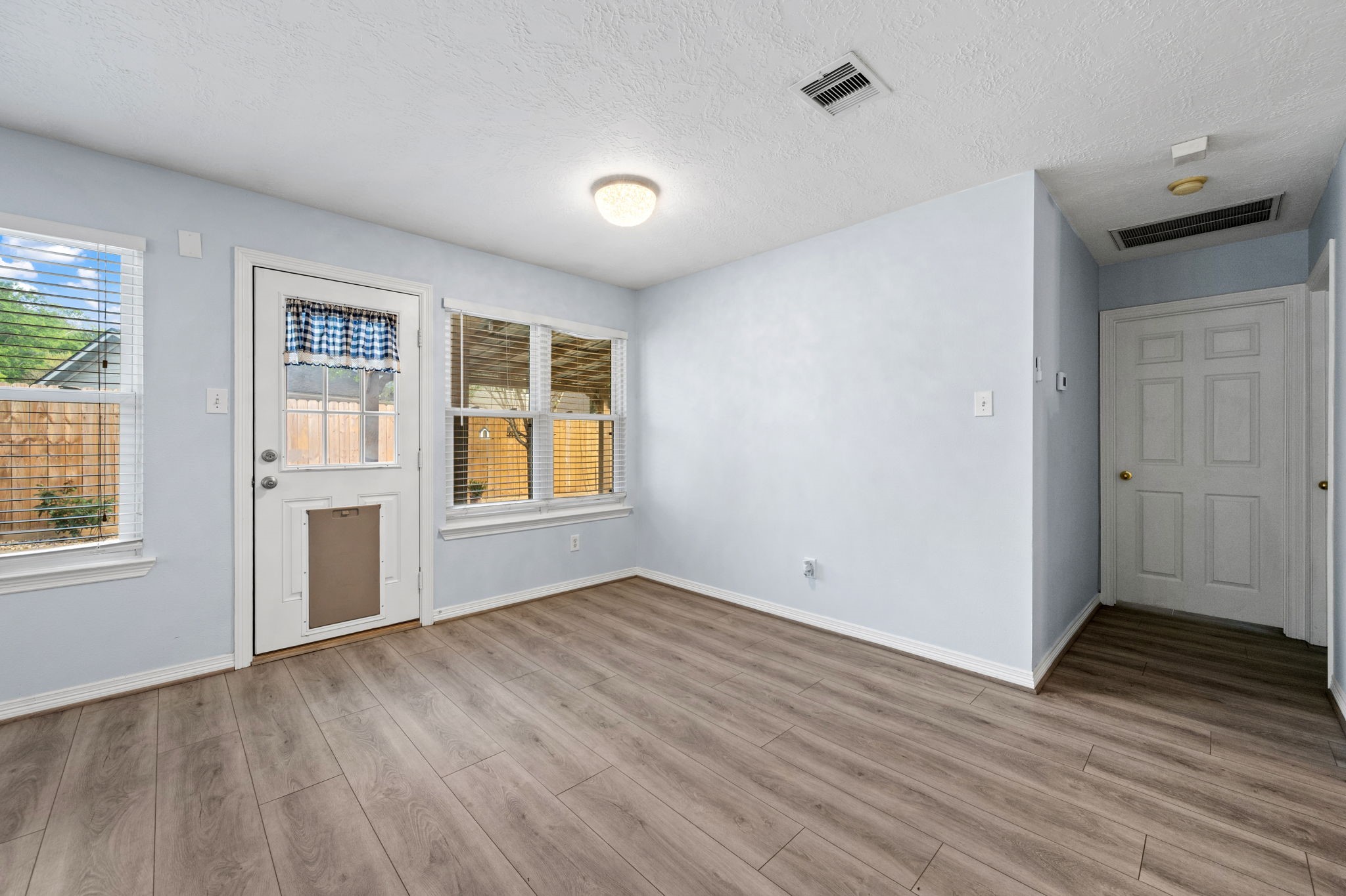 21893 Pinewilde Court Porter, TX 77365 - Photo 21 of 25 a view of an empty room with wooden floor and a window