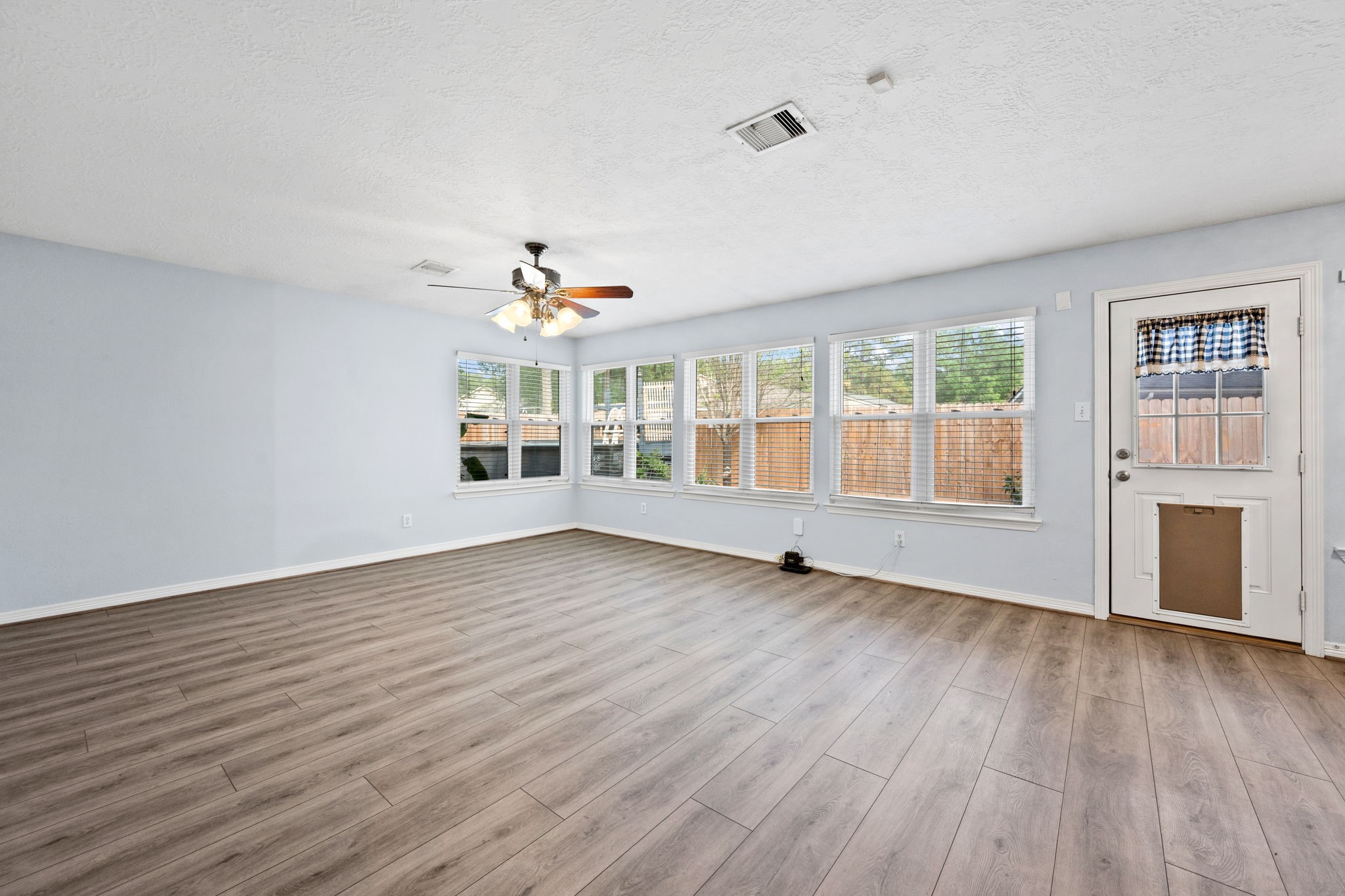 21893 Pinewilde Court Porter, TX 77365 - Photo 22 of 25 a view of an empty room with wooden floor and a window