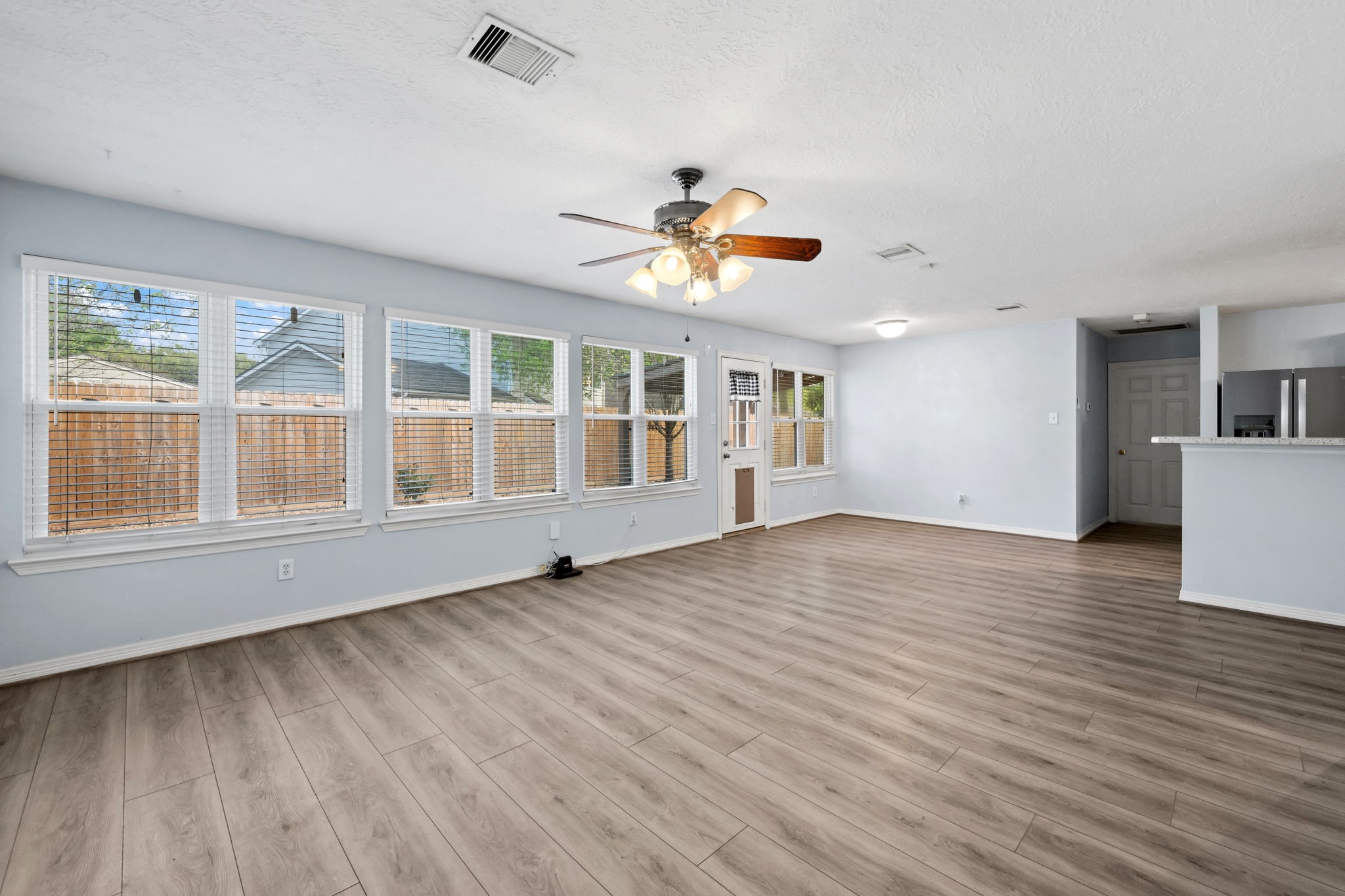 21893 Pinewilde Court Porter, TX 77365 - Photo 23 of 25 an empty room with wooden floor and windows