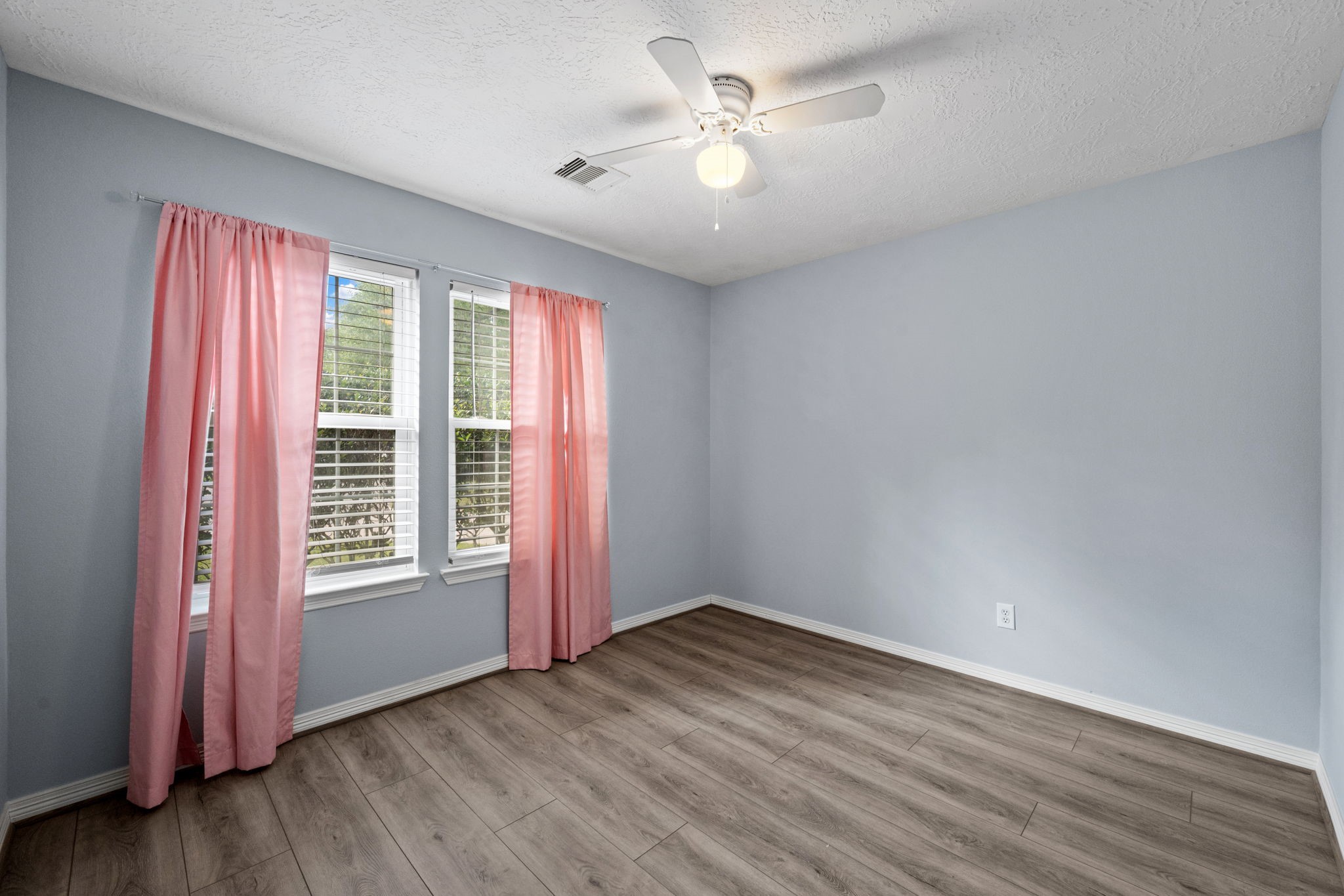 21893 Pinewilde Court Porter, TX 77365 - Photo 24 of 25 an empty room with wooden floor and windows