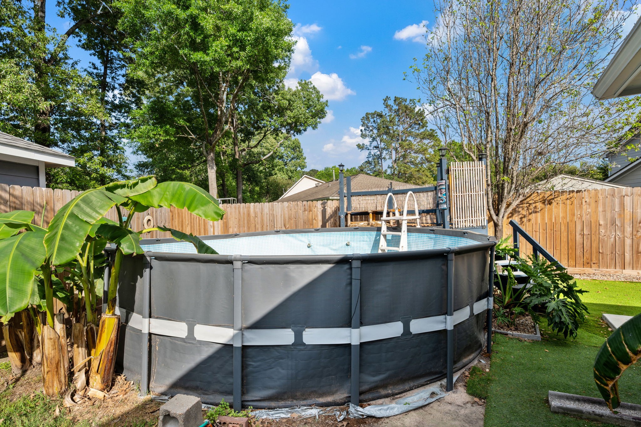 21893 Pinewilde Court Porter, TX 77365 - Photo 6 of 25 a view of backyard with table and chairs potted plants and large tree