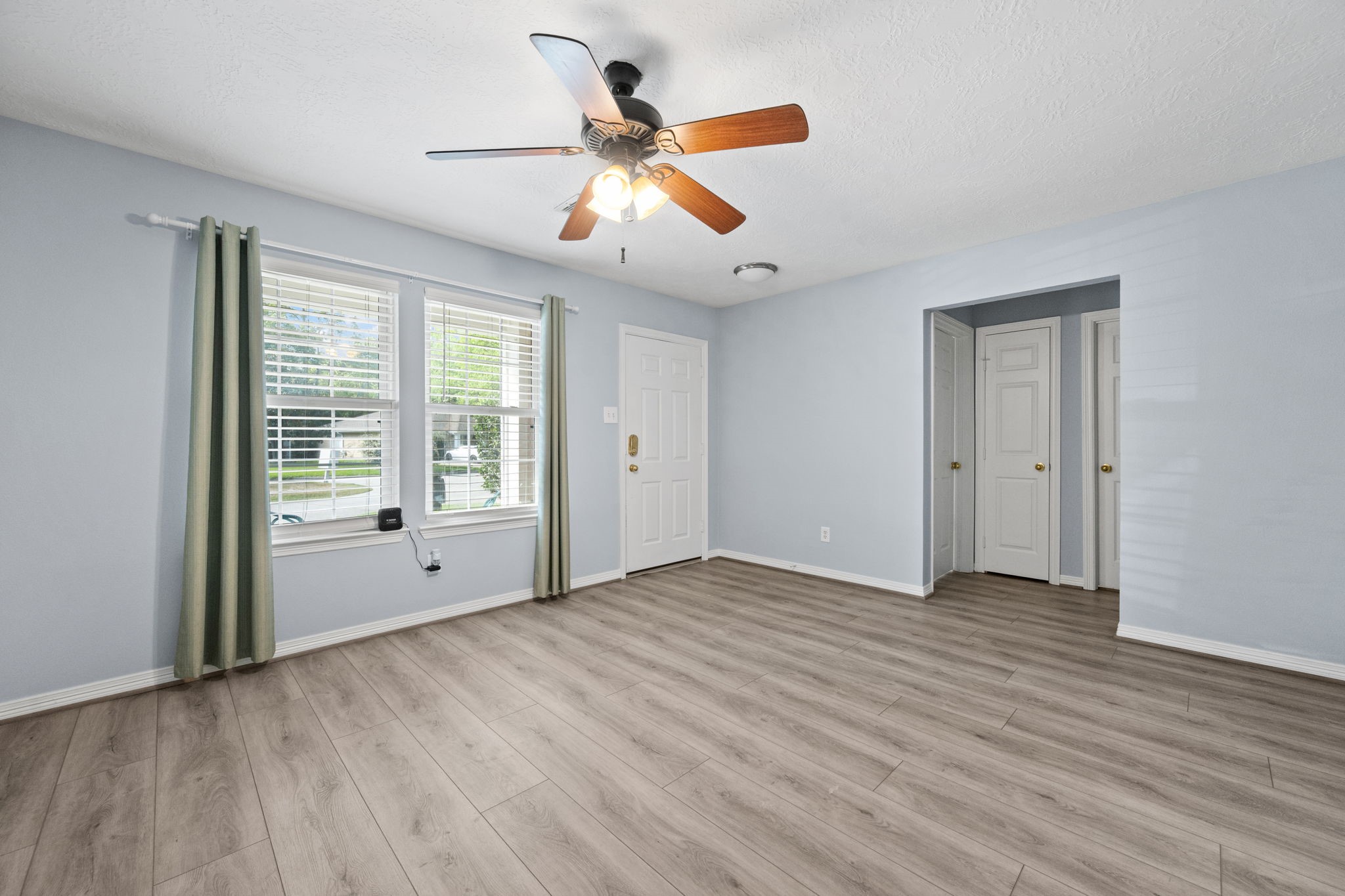 21893 Pinewilde Court Porter, TX 77365 - Photo 9 of 25 a view of an empty room with wooden floor and a window