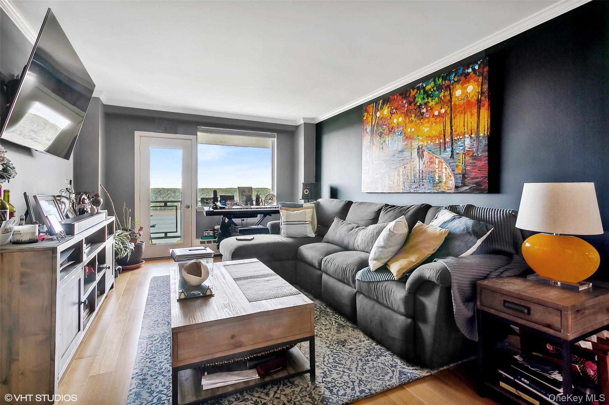 5800 Arlington Avenue, Unit 19L Bronx, NY 10471 - Photo 1 of 19 a living room with furniture and a flat screen tv