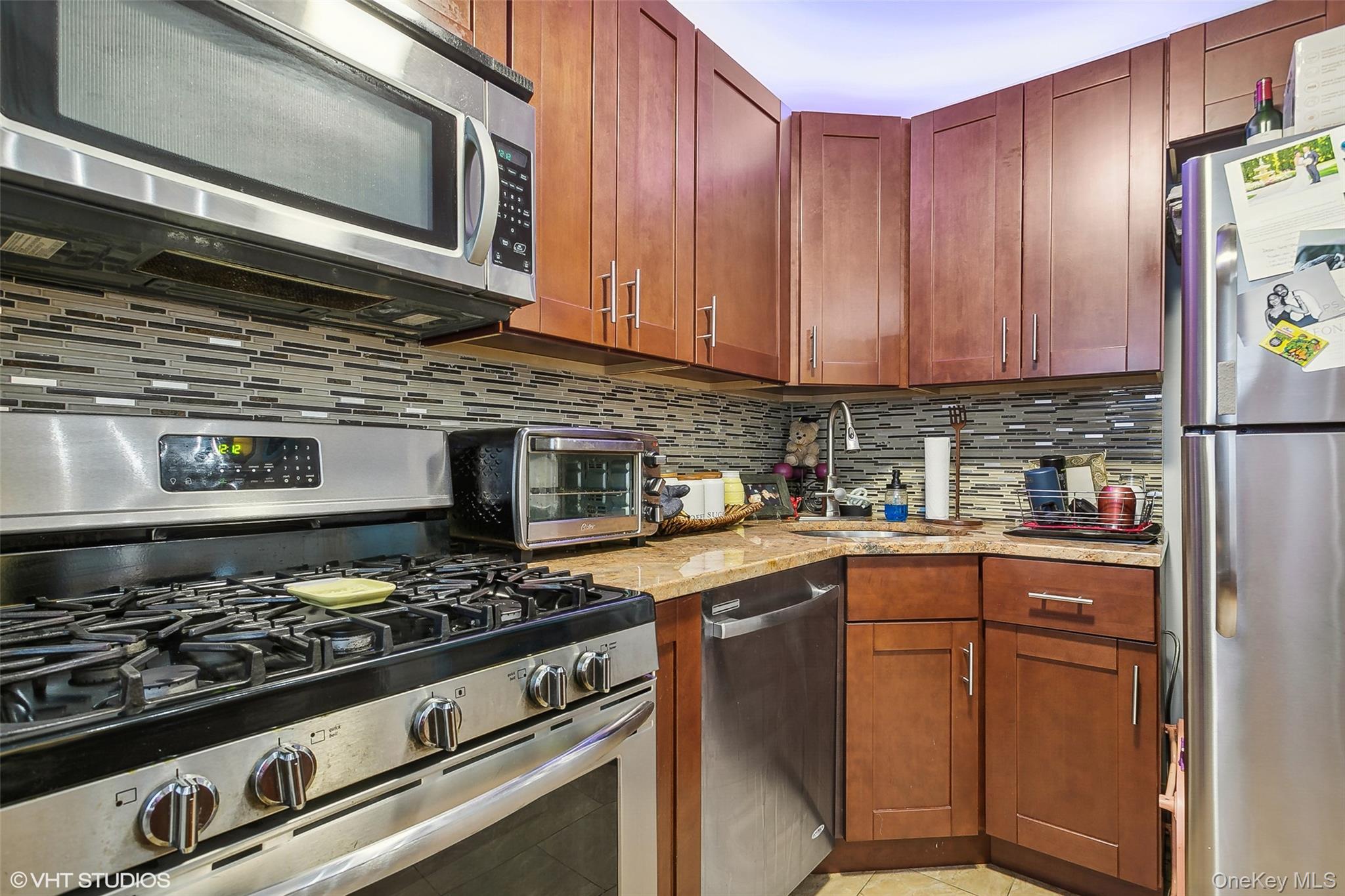 5800 Arlington Avenue, Unit 19L Bronx, NY 10471 - Photo 15 of 19 a kitchen with stainless steel appliances granite countertop a stove and a microwave