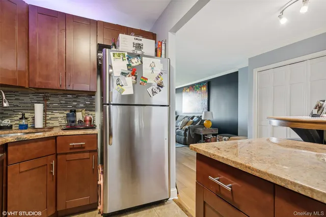 a kitchen with stainless steel appliances granite countertop a refrigerator and a sink