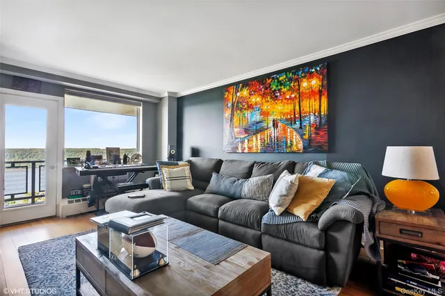 a living room with furniture and a floor to ceiling window