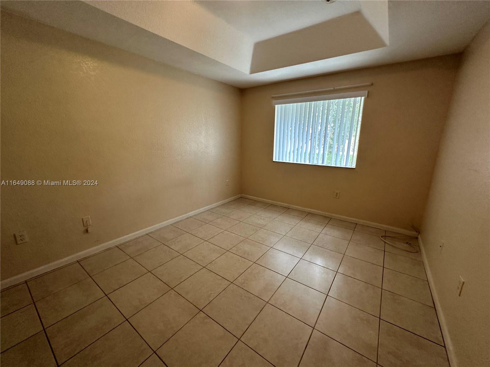 2720 Southeast 15th Road, Unit 13 Homestead, FL 33035 - Photo 3 of 5 an empty room with windows