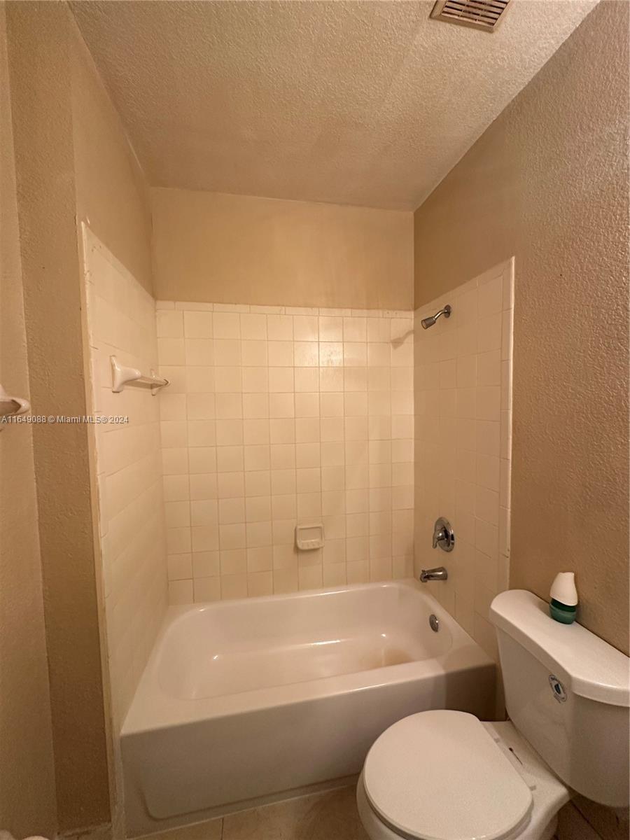 2720 Southeast 15th Road, Unit 13 Homestead, FL 33035 - Photo 4 of 5 a bathroom with a toilet and a bath tub