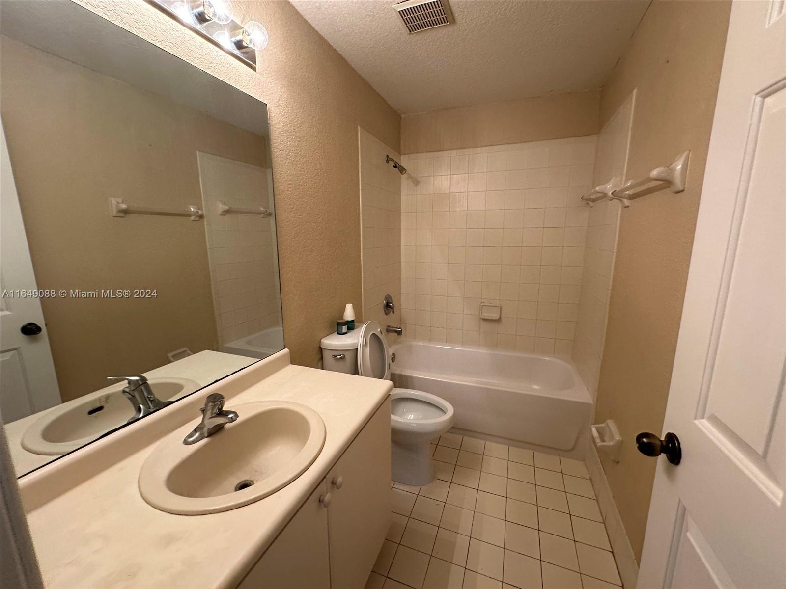 2720 Southeast 15th Road, Unit 13 Homestead, FL 33035 - Photo 5 of 5 a bathroom with a sink a toilet and shower