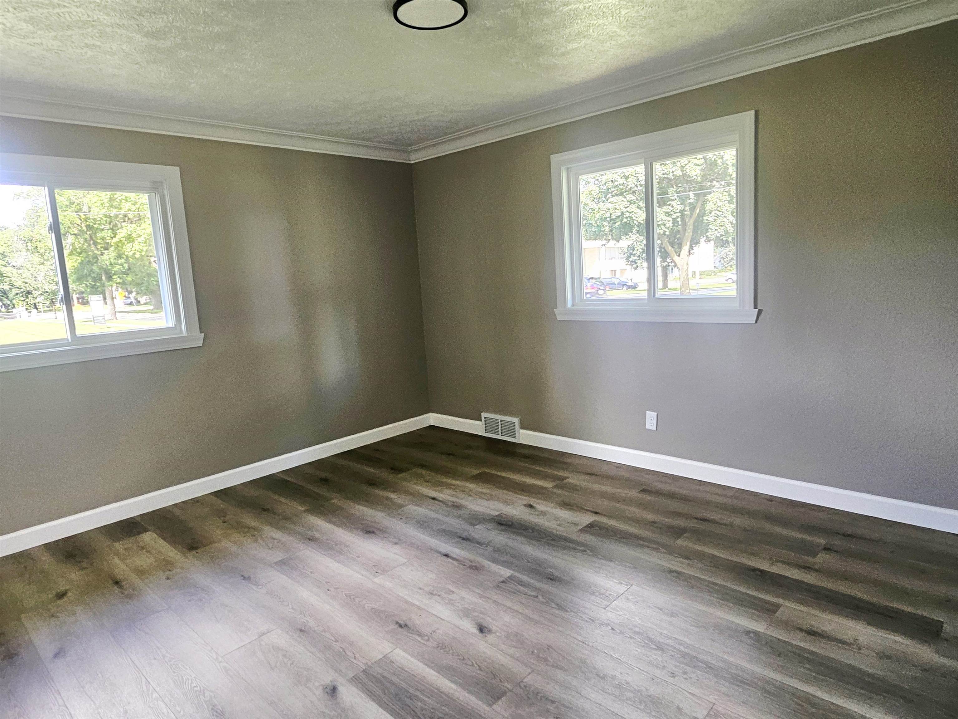 3121 Rural Street Rockford, IL 61107 - Photo 13 of 23 an empty room with wooden floor and windows