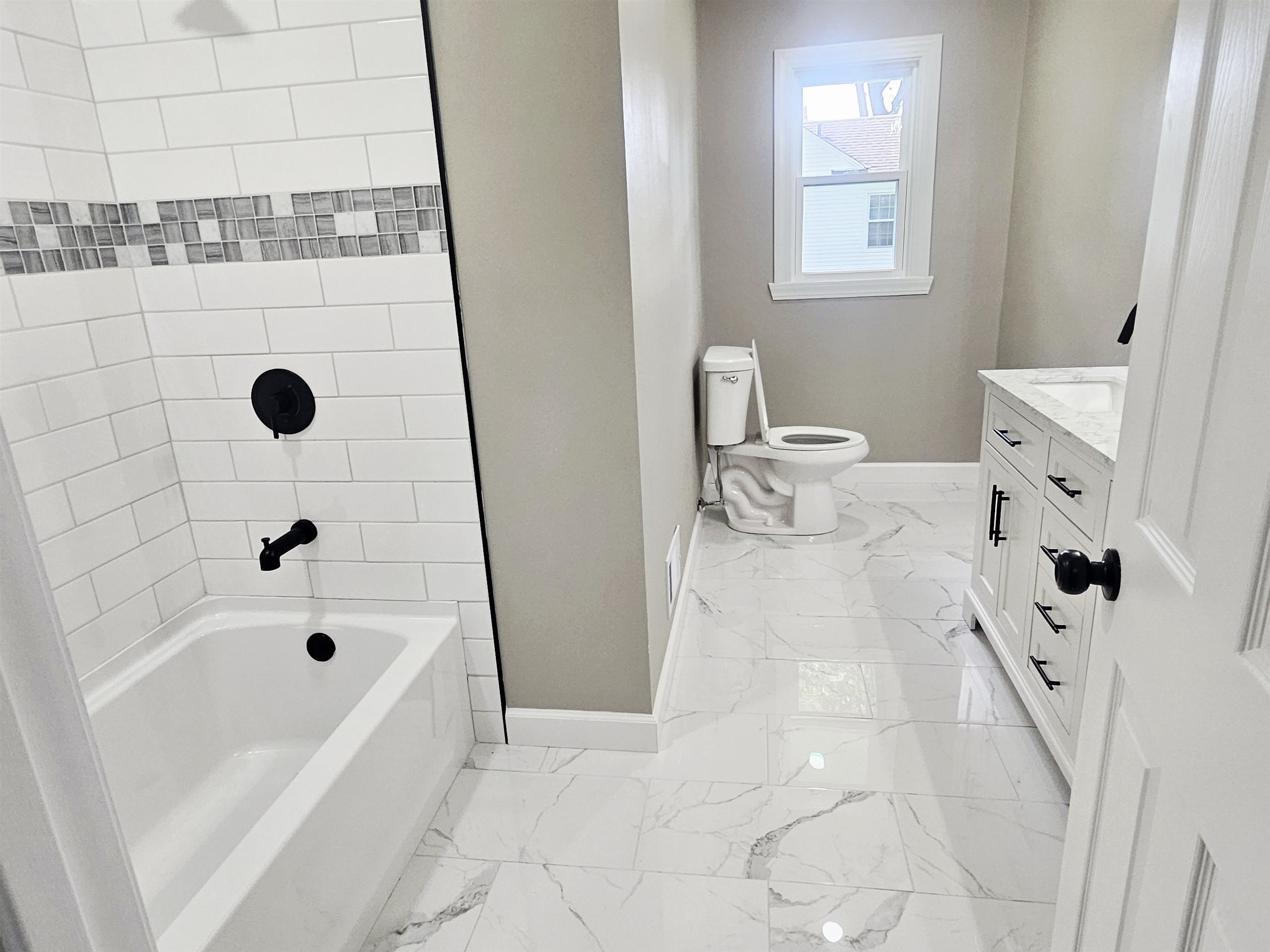 3121 Rural Street Rockford, IL 61107 - Photo 16 of 23 a bathroom with a bathtub sink toilet and shower