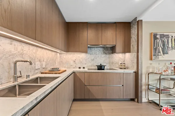a kitchen with stainless steel appliances granite countertop a refrigerator sink and cabinets