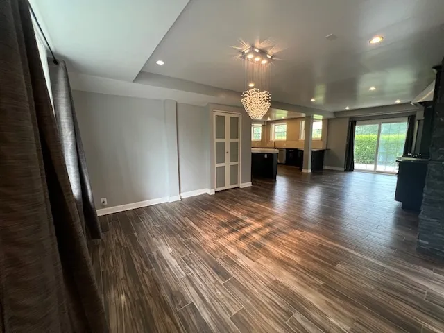 a kitchen with stainless steel appliances a stove and wooden floor