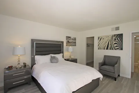 a bed room with a bed and a television