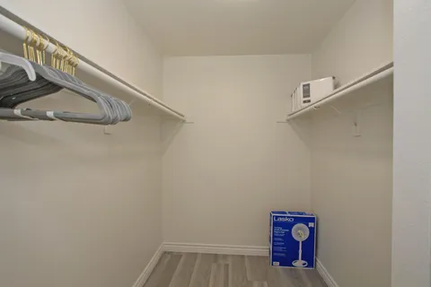 a bathroom with a granite countertop sink a mirror a shower and a toilet